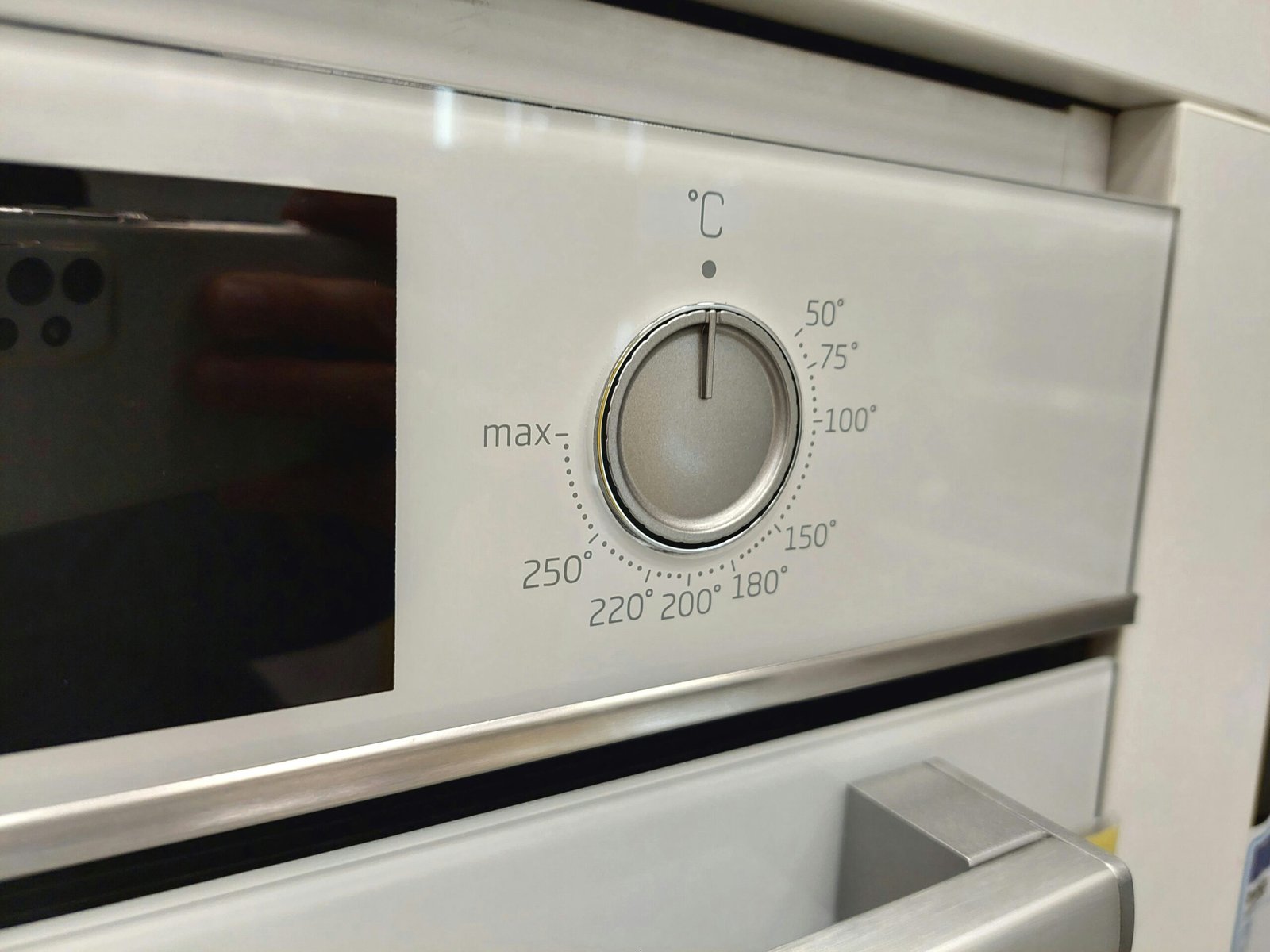 a close up of a stove with a knob on it