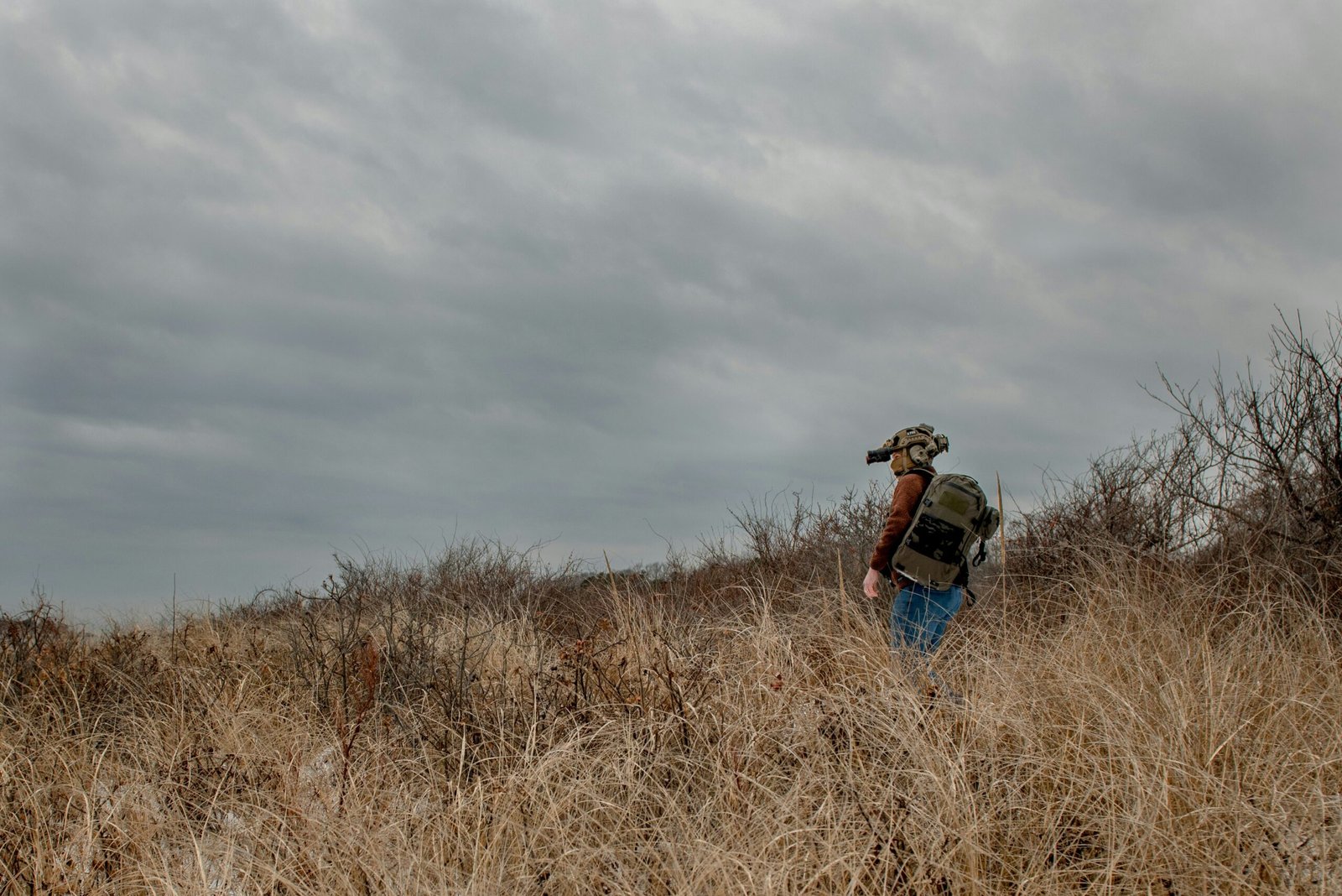a man walking through tall grass